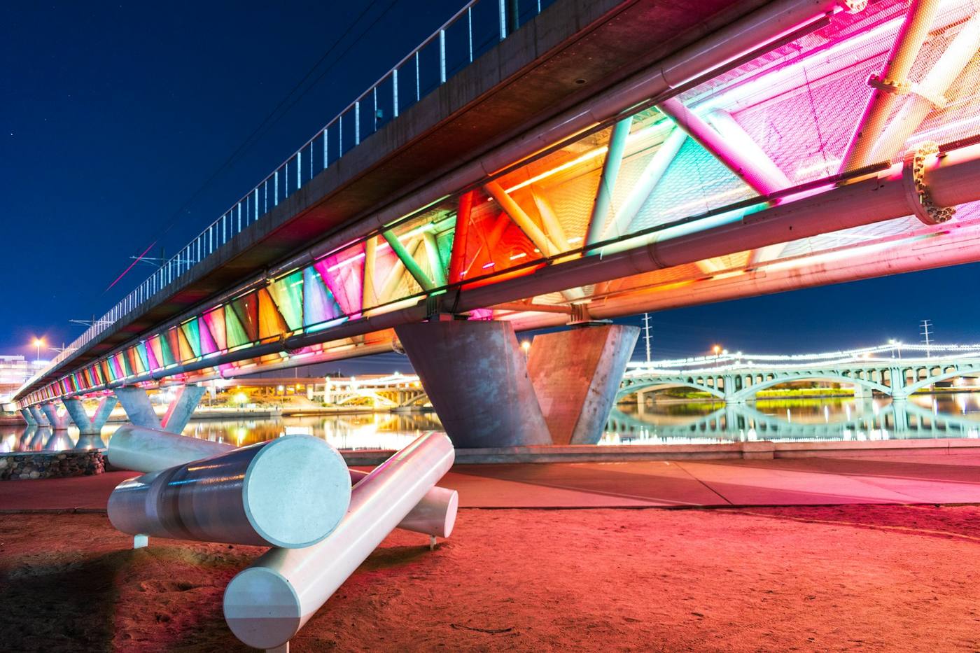 The lit pedestrian bridge over Tempe Town Lake at night