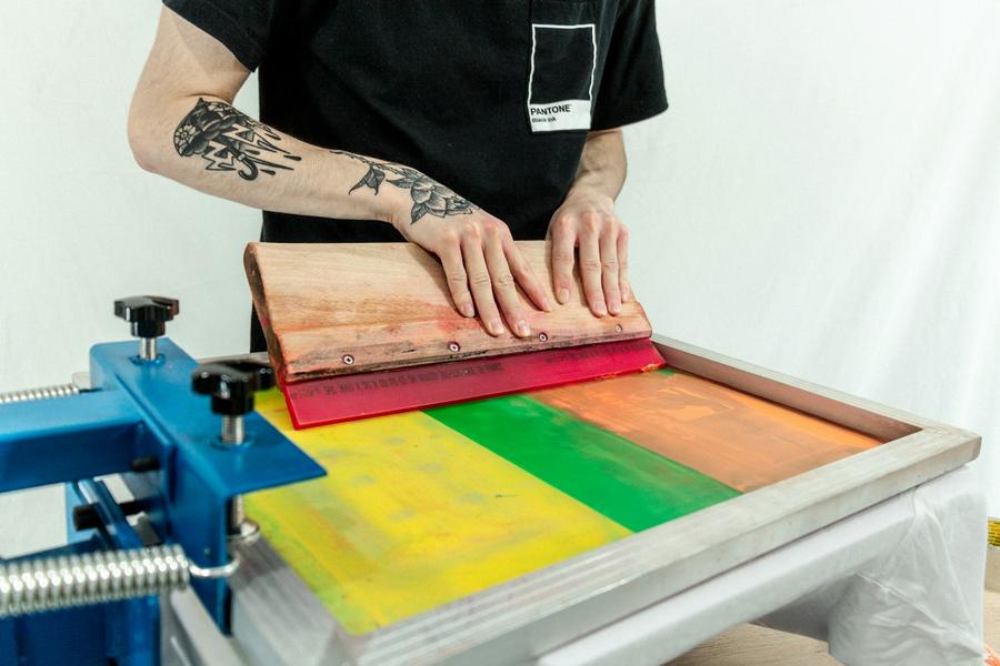 Screen locked into a press with fresh ink