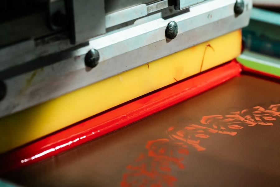 Squeegee laying down red ink