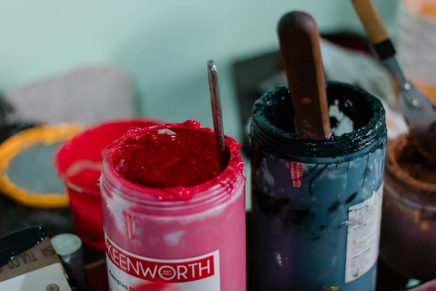 Open buckets of screen printing ink